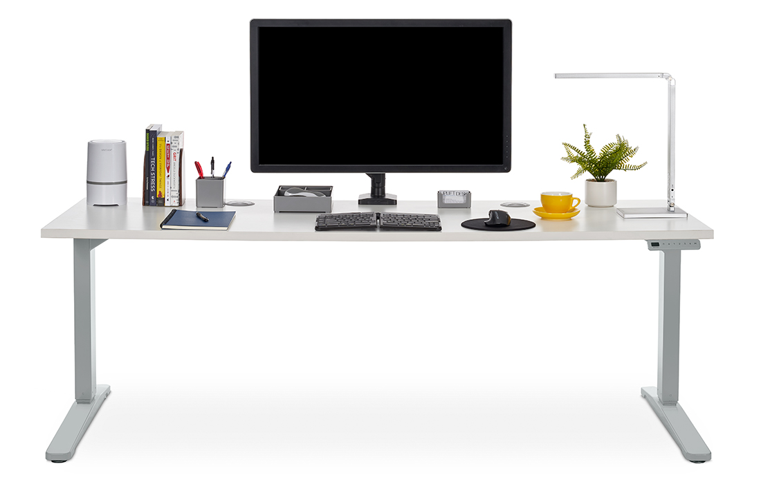 A black Crestview Single Monitor Arm attached to a 72 x 30 White Laminate Standing Desk