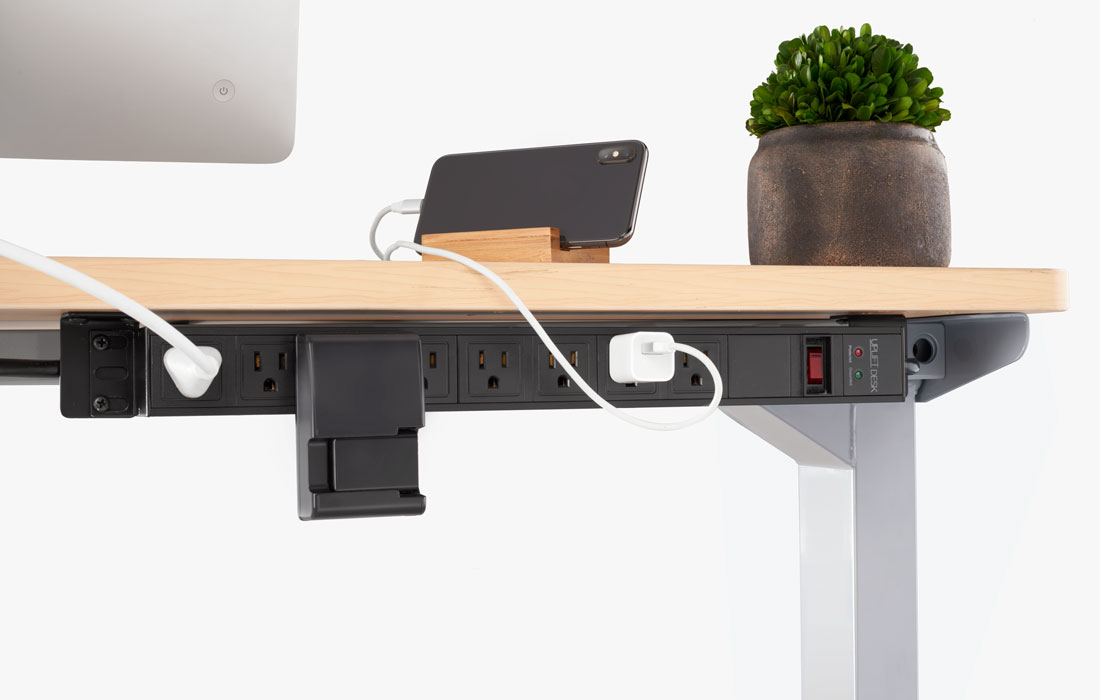 An 8-Outlet Mountable Surge Protector mounted directly to the frame of a V2 Standing Desk Frame
