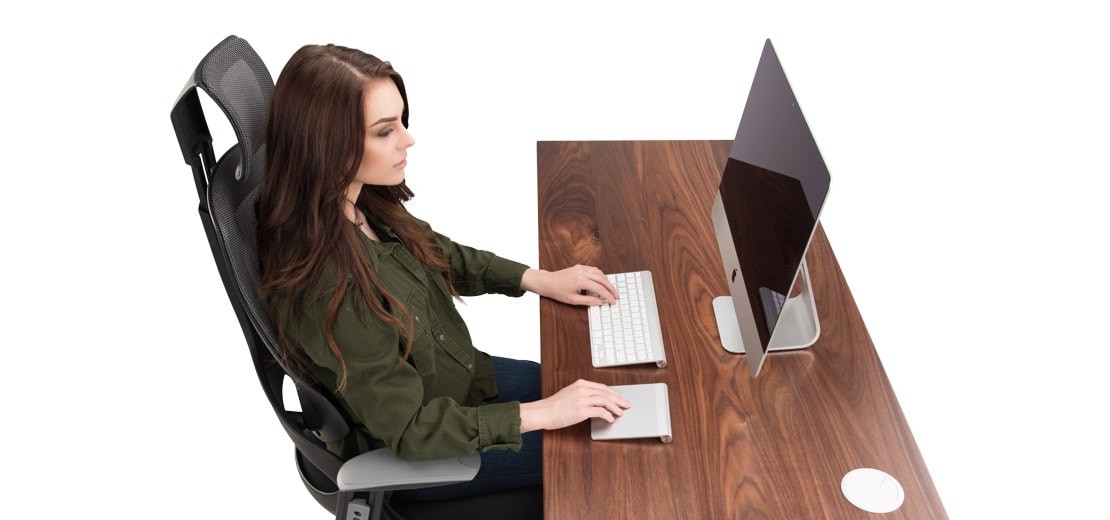 A woman works at an ergonomic office chair